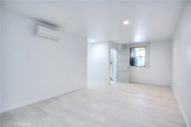 an empty room with windows and bathroom