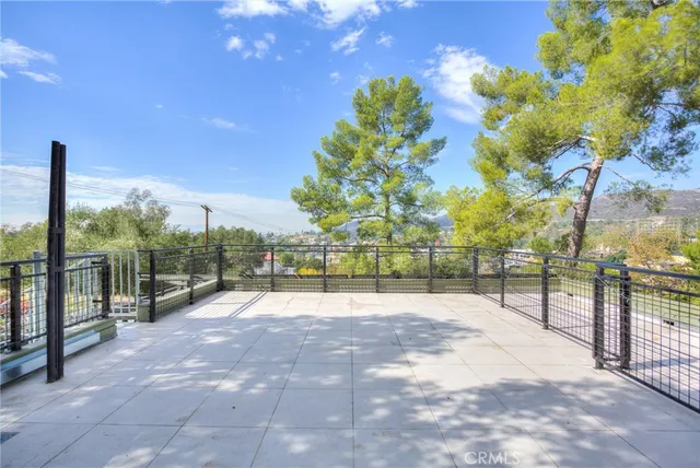 a view of flowing garden with wooden fence