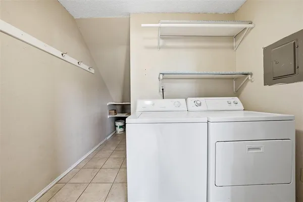 a kitchen with granite countertop white cabinets a window and stainless steel appliances