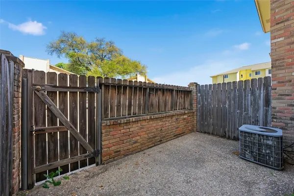 a backyard of a house with barbeque oven