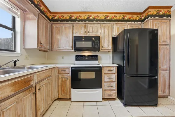 a kitchen with stainless steel appliances a refrigerator and microwave