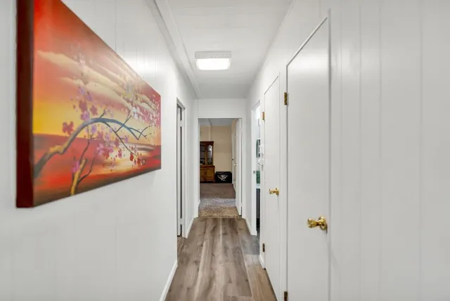a view of a hallway with wooden floor