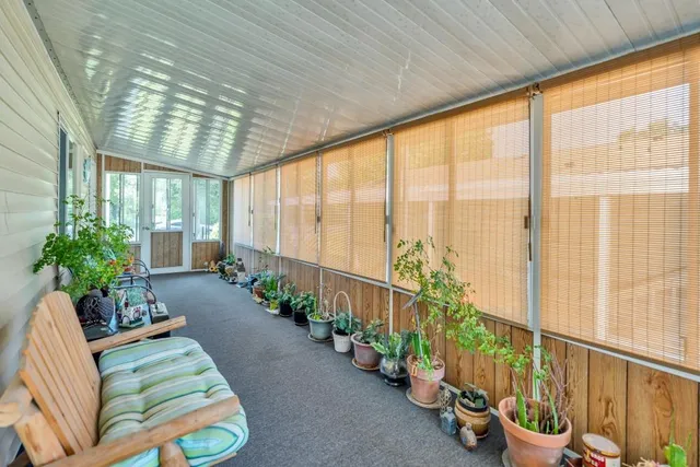 a view of a porch with a table and chair