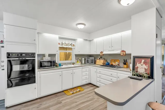 a kitchen with sink cabinets and microwave