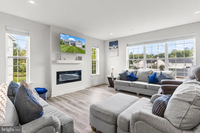 a living room with furniture and a view of kitchen