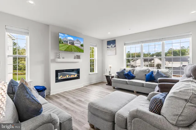 a kitchen with stainless steel appliances granite countertop a table chairs sink refrigerator and cabinets