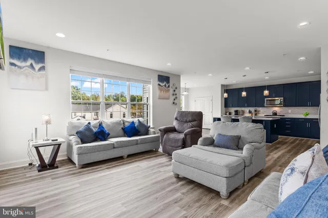 a large kitchen with stainless steel appliances a stove a sink a refrigerator and a refrigerator