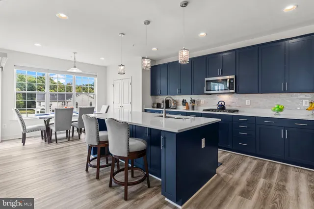 a kitchen with lots of counter space and wooden floor
