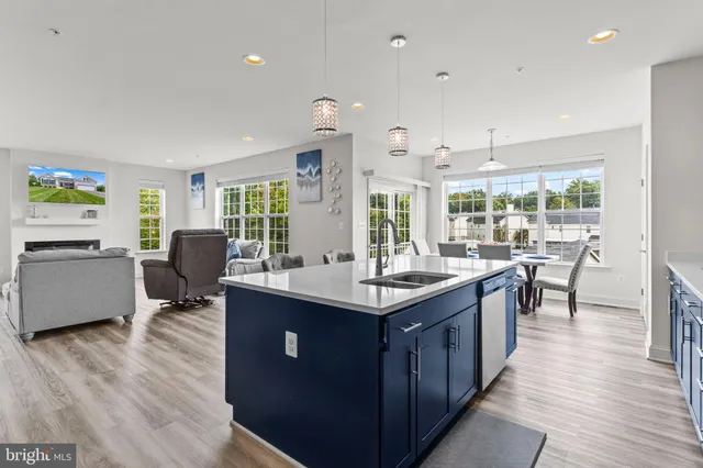 a kitchen with granite countertop stainless steel appliances wooden cabinets and a sink