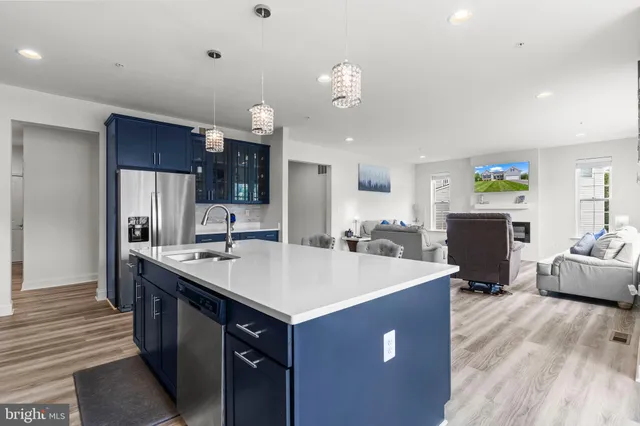 a kitchen with stainless steel appliances granite countertop a sink refrigerator and microwave