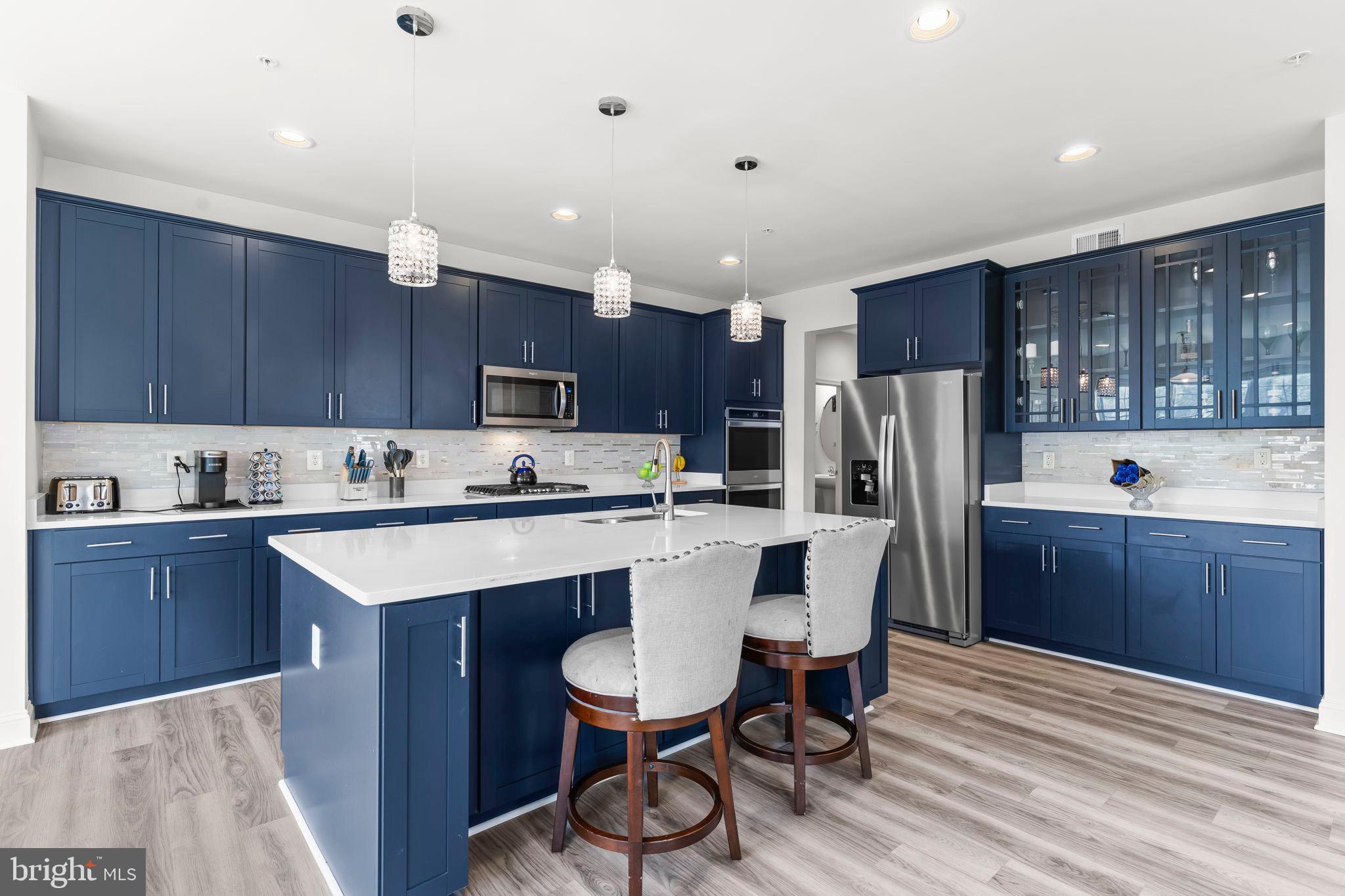 9104 Rama Court Clinton, MD 20735 - Photo 36 of 62 Sleek modern kitchen with navy cabinetry.