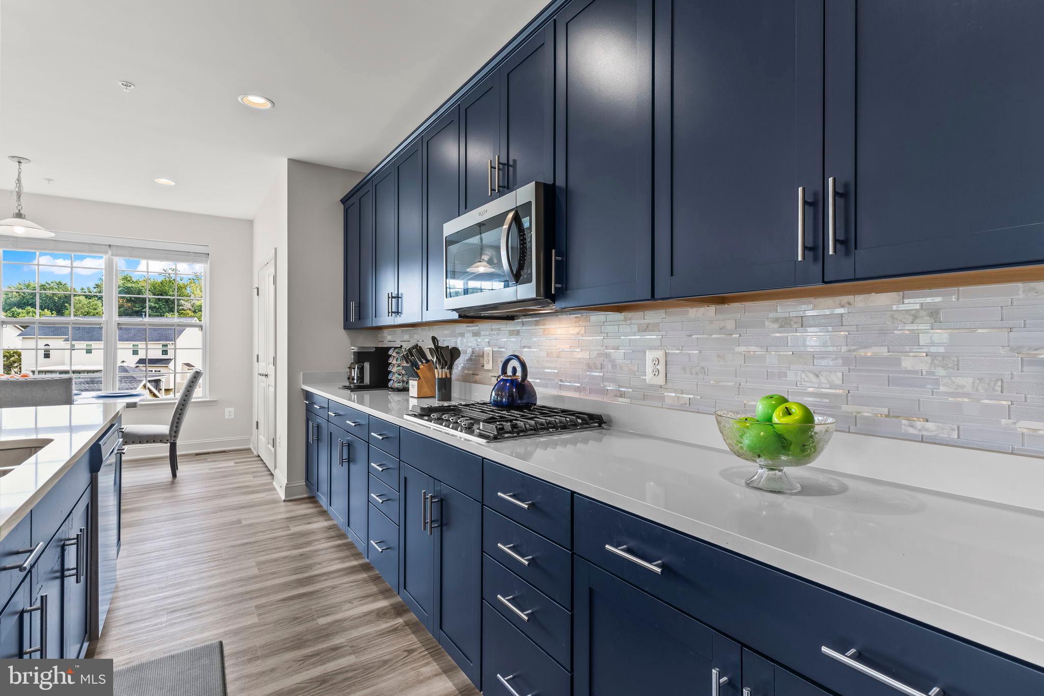 9104 Rama Court Clinton, MD 20735 - Photo 38 of 62 Modern kitchen with sleek navy cabinetry.