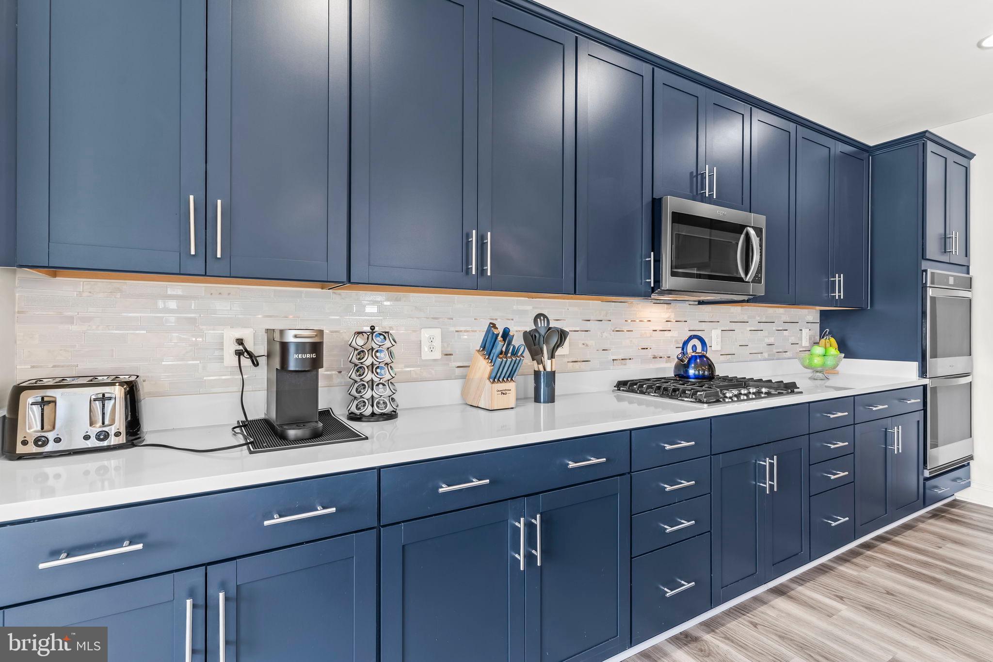 9104 Rama Court Clinton, MD 20735 - Photo 39 of 62 Sleek navy kitchen with modern finishes.