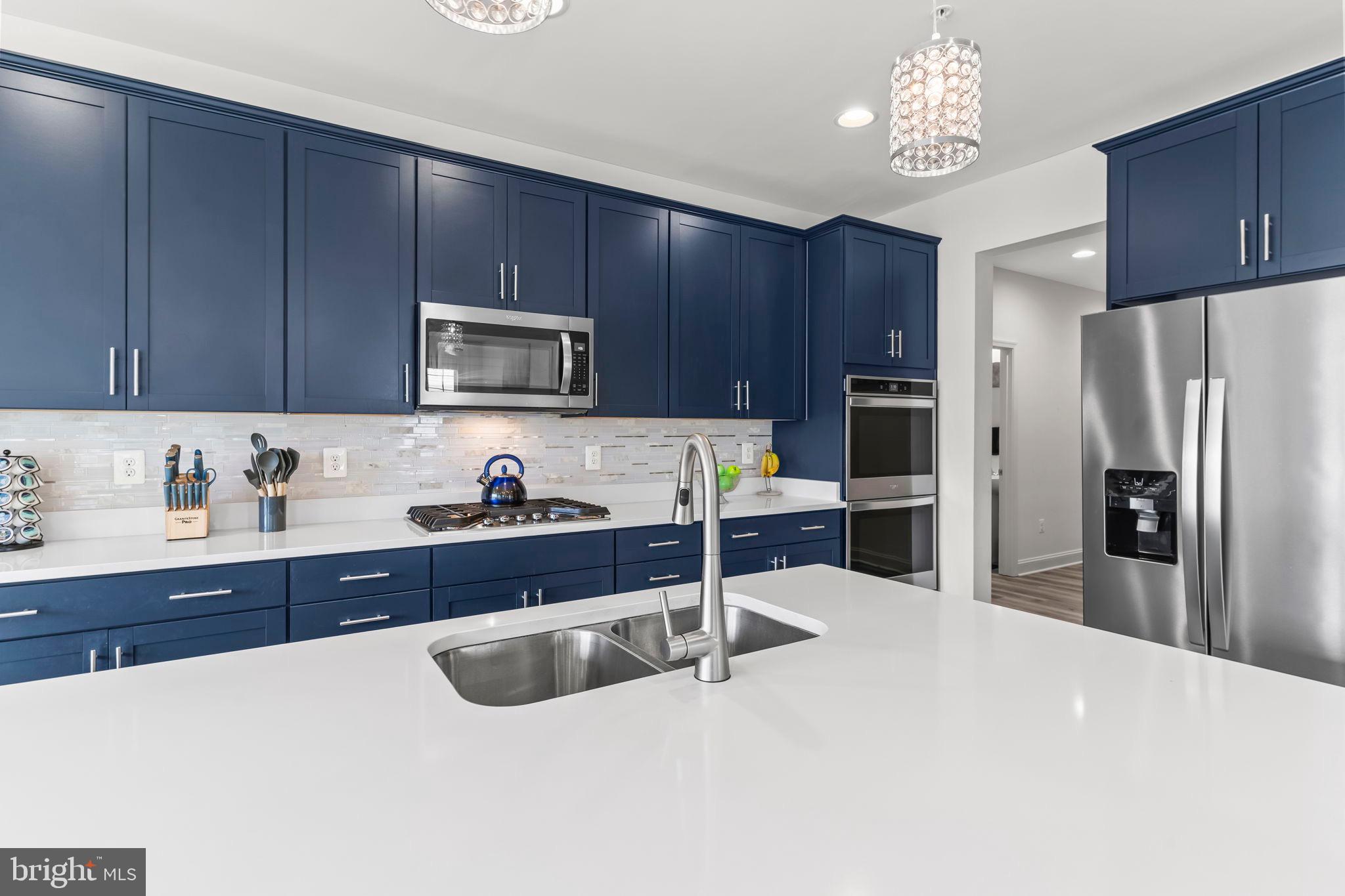 9104 Rama Court Clinton, MD 20735 - Photo 40 of 62 Sleek navy kitchen with modern finishes.
