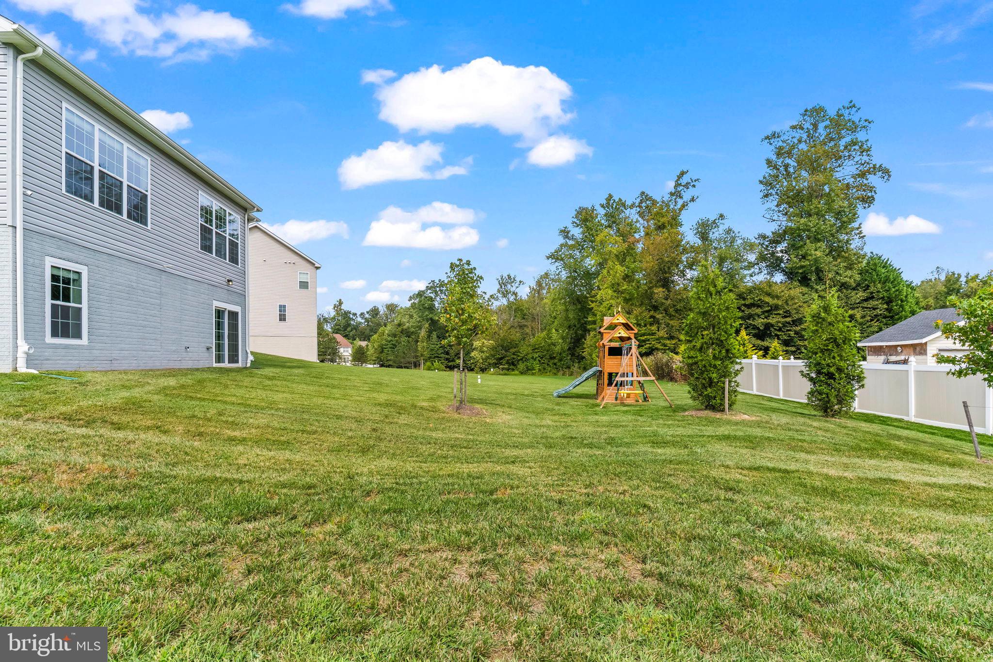 9104 Rama Court Clinton, MD 20735 - Photo 58 of 62 Spacious backyard with playset and greenery.