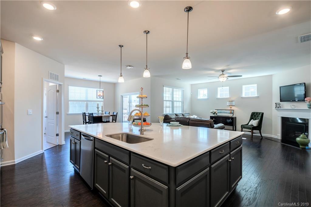 a kitchen with sink stove and wooden floor
