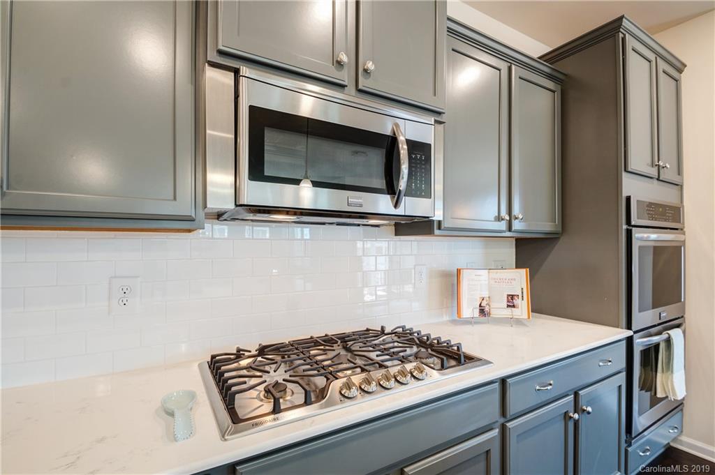 1014 Bannister Road Waxhaw, NC 28173 - Photo 14 of 48 a kitchen with stainless steel appliances a stove a microwave and cabinets