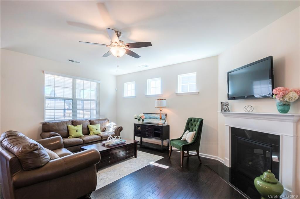 1014 Bannister Road Waxhaw, NC 28173 - Photo 18 of 48 a living room with furniture a fireplace and a flat screen tv