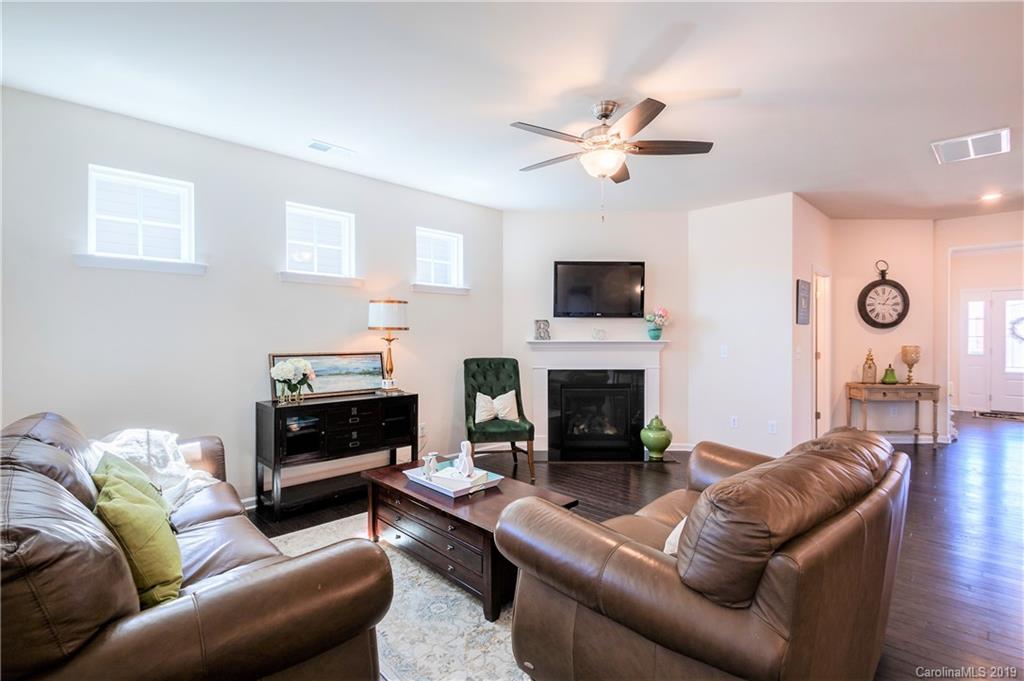 1014 Bannister Road Waxhaw, NC 28173 - Photo 20 of 48 a living room with furniture a fireplace and a flat screen tv