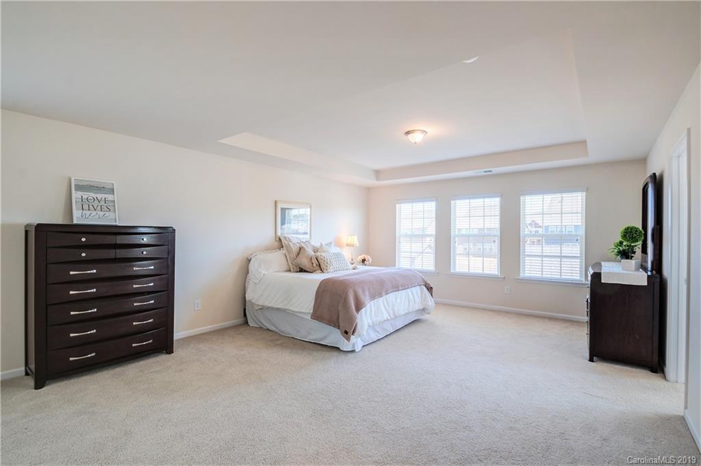 1014 Bannister Road Waxhaw, NC 28173 - Photo 22 of 48 a spacious bedroom with a bed and a dresser
