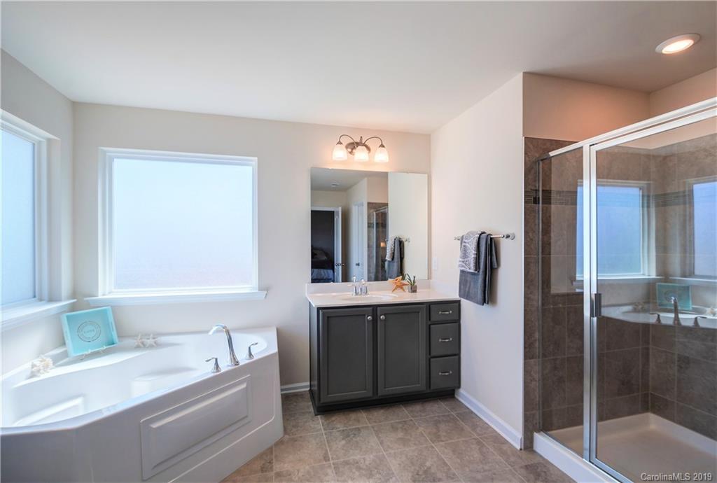 1014 Bannister Road Waxhaw, NC 28173 - Photo 25 of 48 a bathroom with a tub sink and mirror