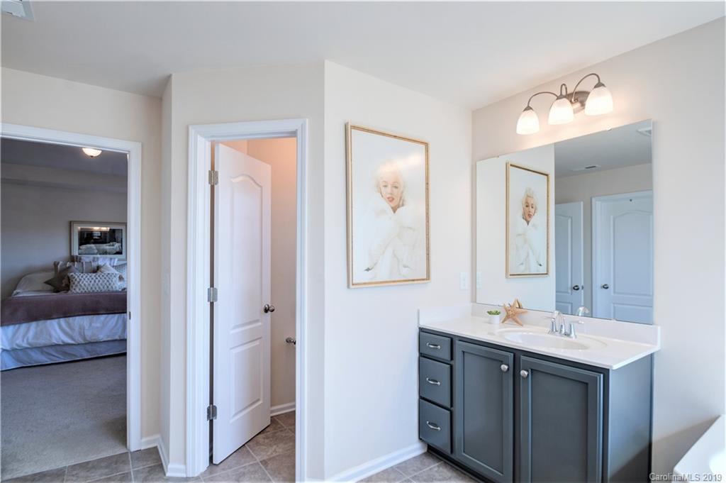 1014 Bannister Road Waxhaw, NC 28173 - Photo 27 of 48 a en suite bathroom with a double vanity sink and a mirror
