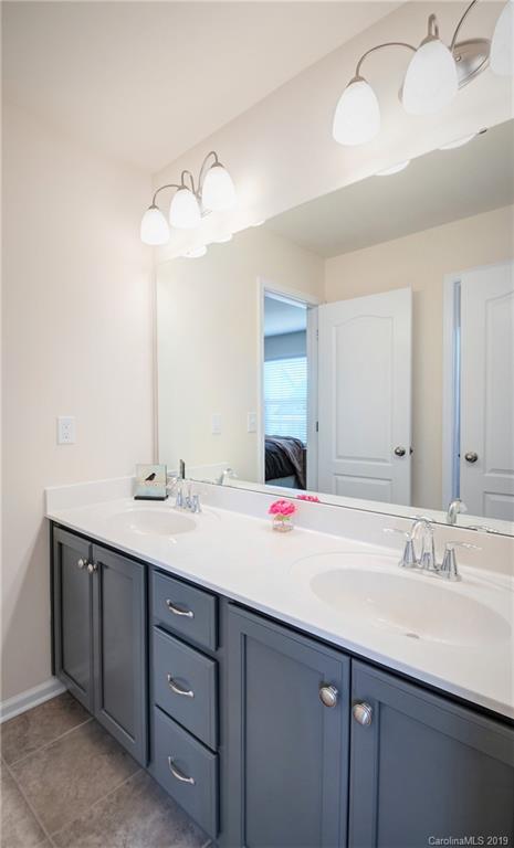 1014 Bannister Road Waxhaw, NC 28173 - Photo 31 of 48 a bathroom with a sink vanity and mirror