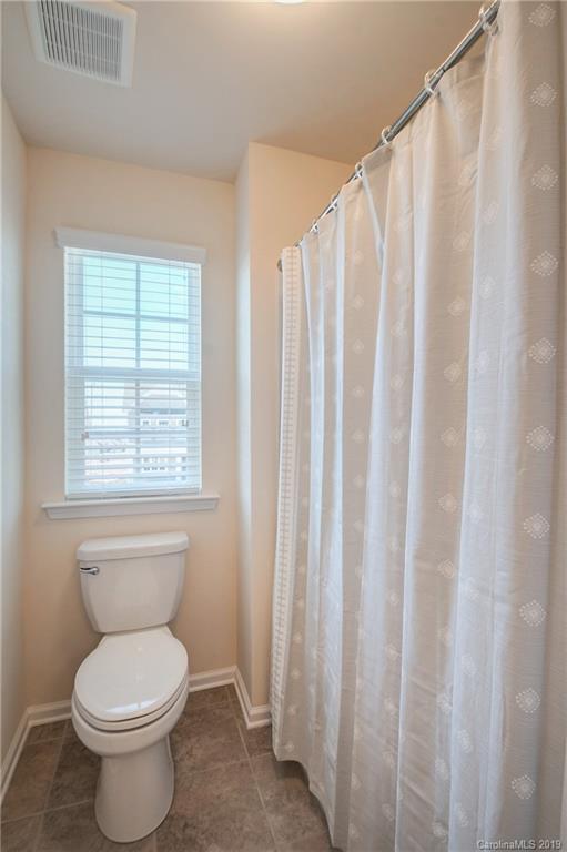 1014 Bannister Road Waxhaw, NC 28173 - Photo 32 of 48 a bathroom with a toilet and a shower curtain