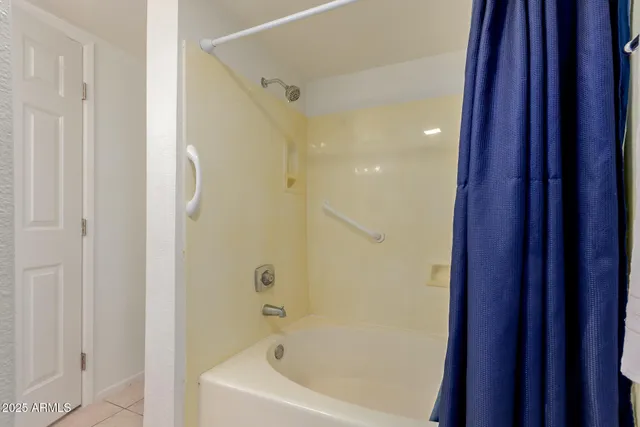 a bathroom with a bathtub and shower