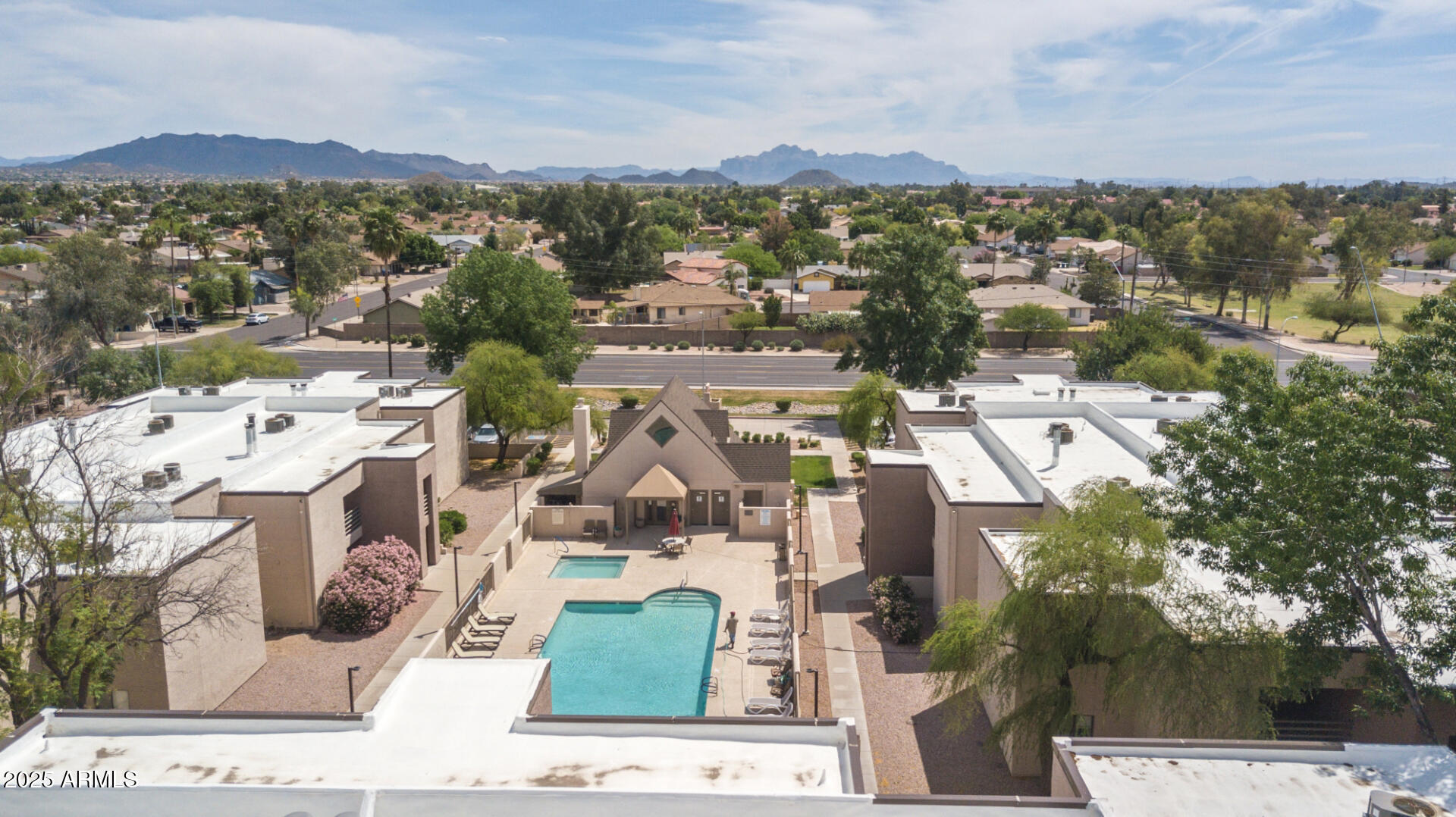 1340 North Recker Road, Unit 133 Mesa, AZ 85205 - Photo 15 of 17 an aerial view of residential houses with outdoor space