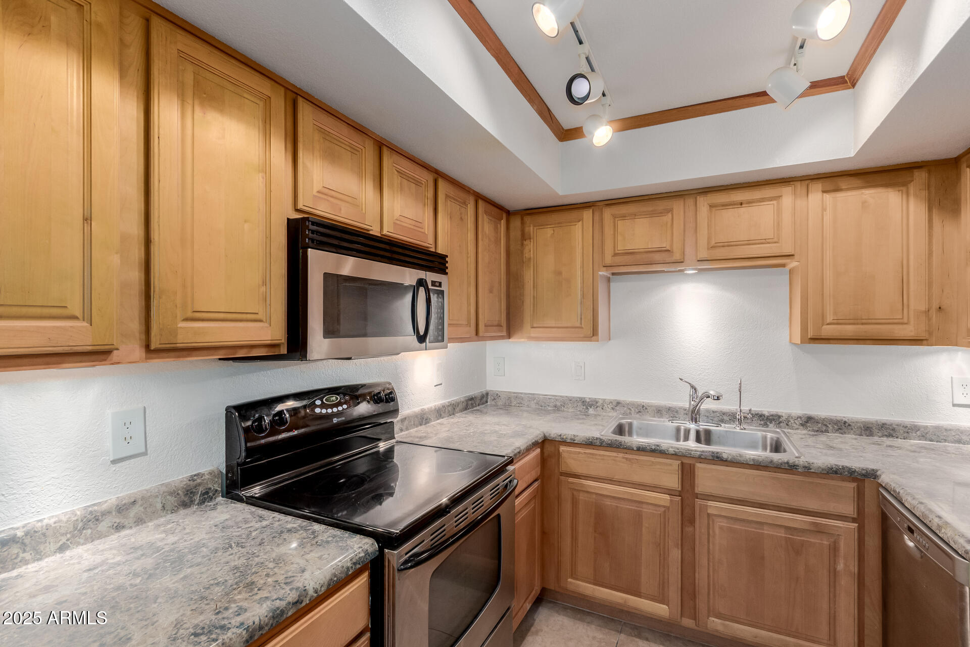 1340 North Recker Road, Unit 133 Mesa, AZ 85205 - Photo 7 of 17 a kitchen that has a sink and a stove in it