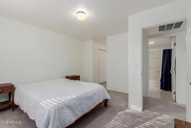 a bedroom with a bed and cabinets