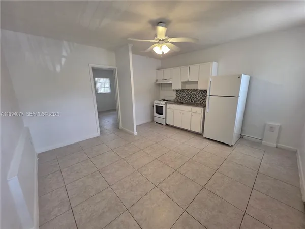 a open kitchen with cabinets and stainless steel appliances