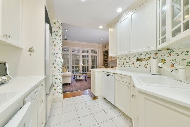 a kitchen with a sink and white cabinets