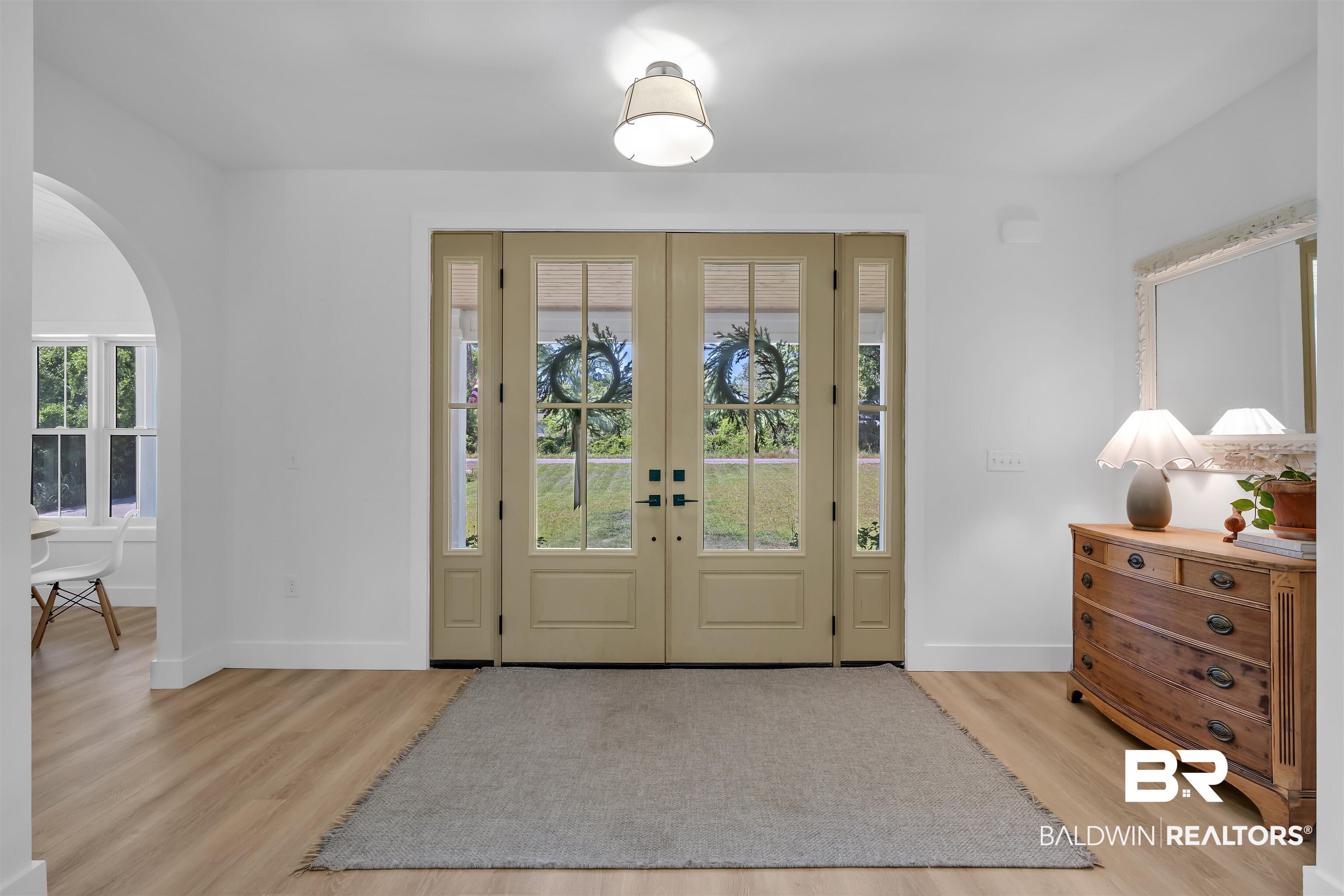 19058 James Road Gulf Shores, AL 36542 - Photo 5 of 49 Foyer entrance featuring french doors, light wood-style floors, and arched walkways