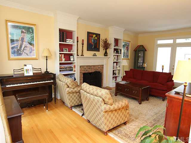 2512 Ashley Court Raleigh, NC 27607 - Photo 2 of 24 Home opens to spacious living room with gas (LP) log fireplace and great builtins. Oversized windows take advantage of southern exposure. Living Room