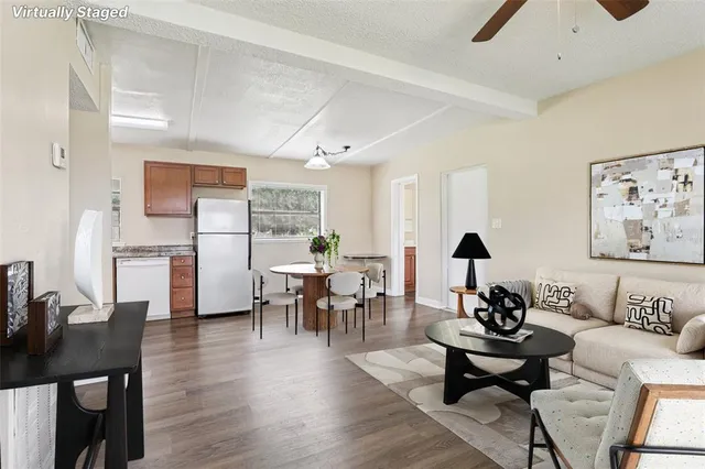 a living room with furniture and wooden floor