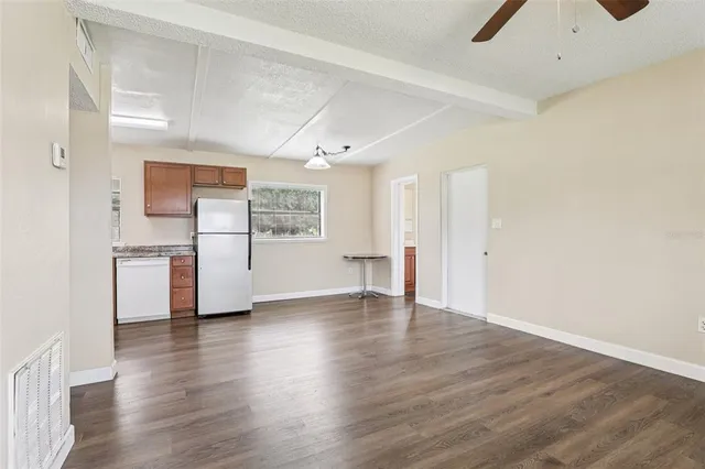 a view of a kitchen with a sink and a refrigerator