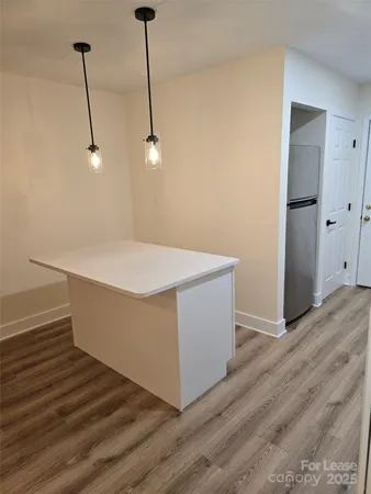 a room with wooden floor and white walls