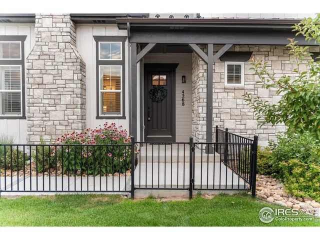 a view of a house with wooden fence