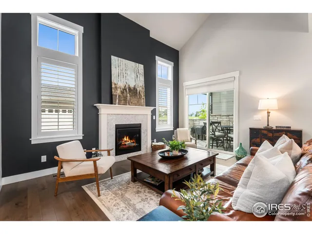 a living room with furniture a table and a fireplace