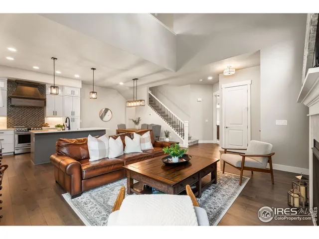 a living room with lots of furniture and kitchen view