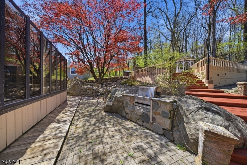 7 Pathfinder Trail Wharton, NJ 07885 - Photo 38 of 46 a street view with wooden fence and trees