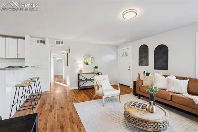 a living room with furniture and wooden floor