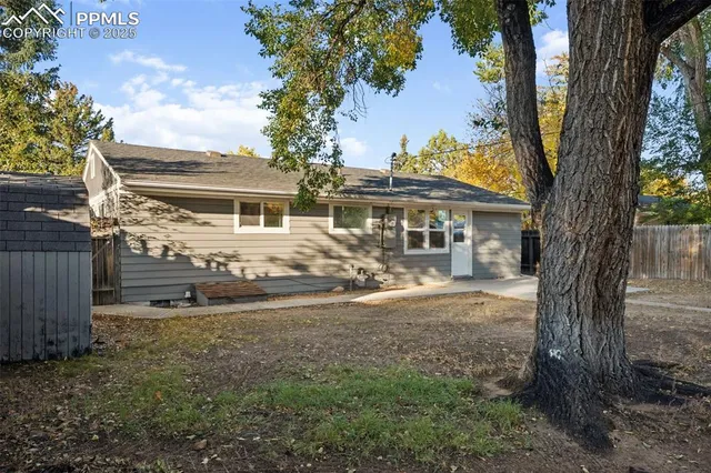 a view of a house with a tree in the yard