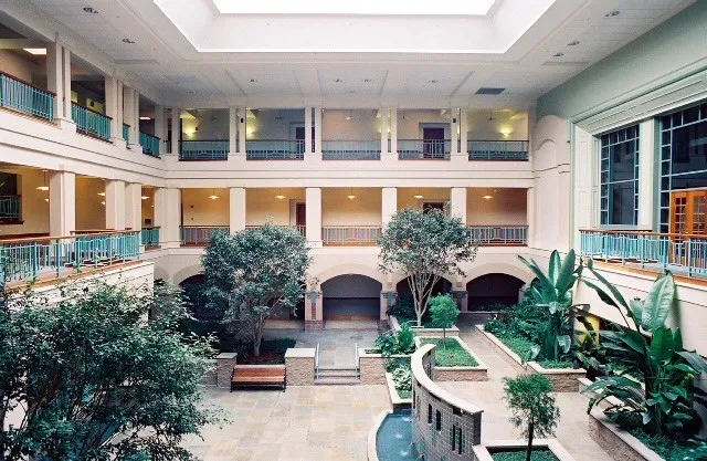 a view of a patio with couches table and chairs and potted plants