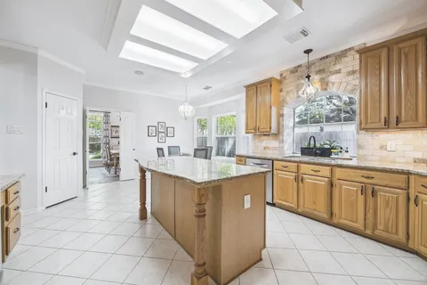 a kitchen with granite countertop a sink and cabinets