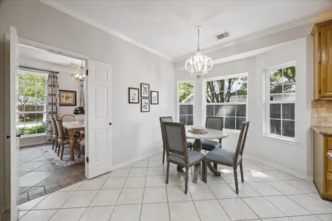 a view of a dining room with furniture and windows