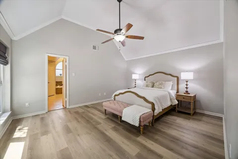 a bedroom with a bed and a ceiling fan