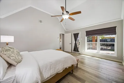 a bedroom with a large bed and a window